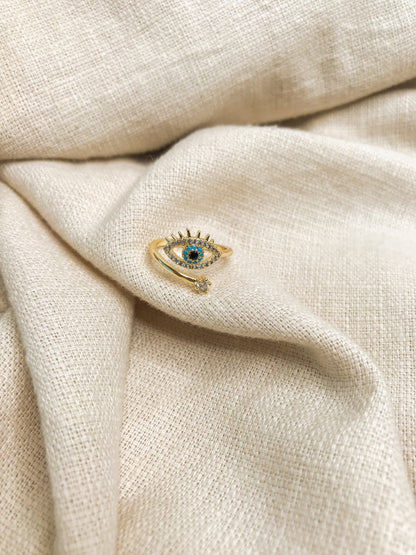anillo diseño de ojo con piedra azul y brillantes